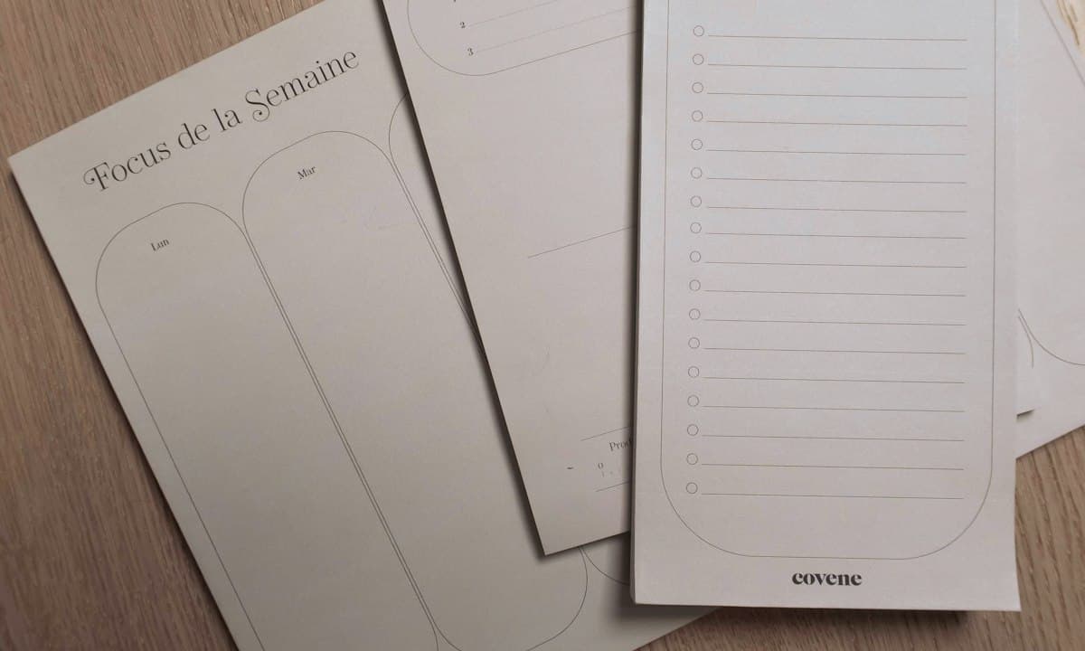 Three notebooks on a wooden table